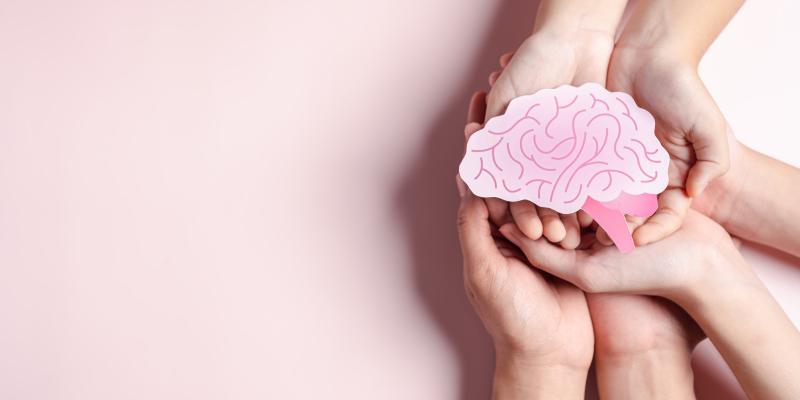 Image of hands holding a drawn picture of a brain