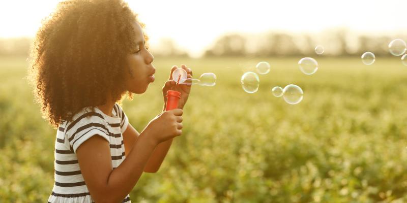 girl blowing bubbles