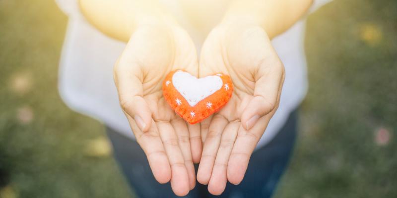 A felt heart in hands