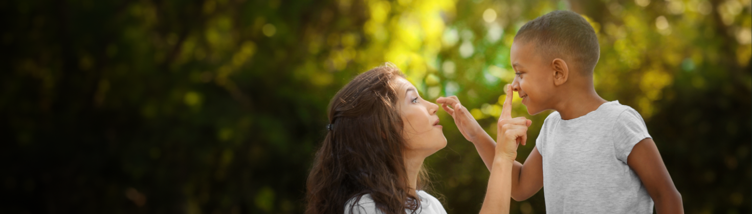 A woman and child touching each other's nose