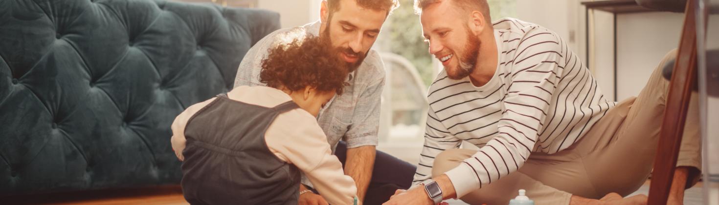 Two men playing with young child