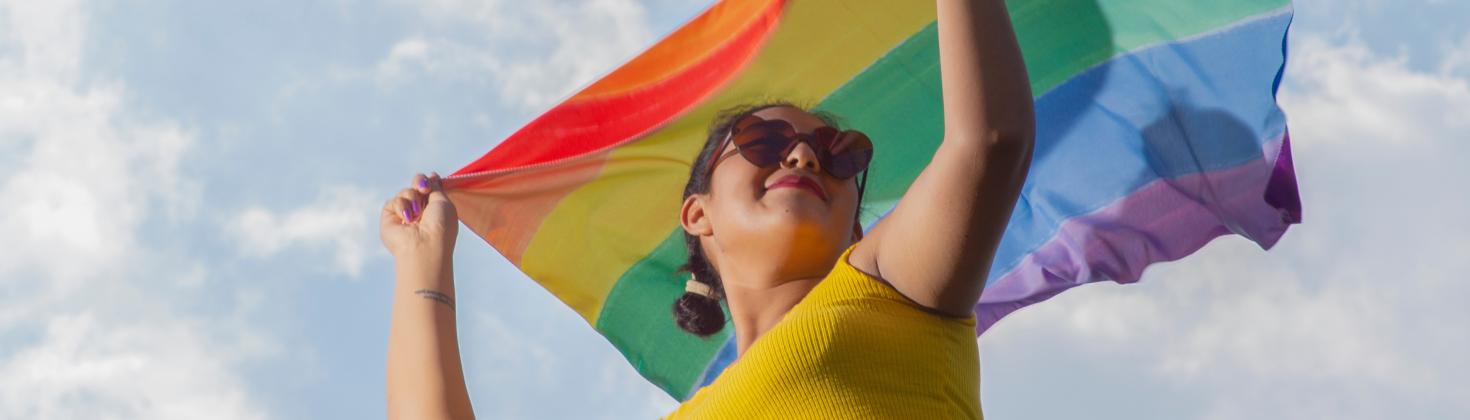 Female holding rainbow pride flag
